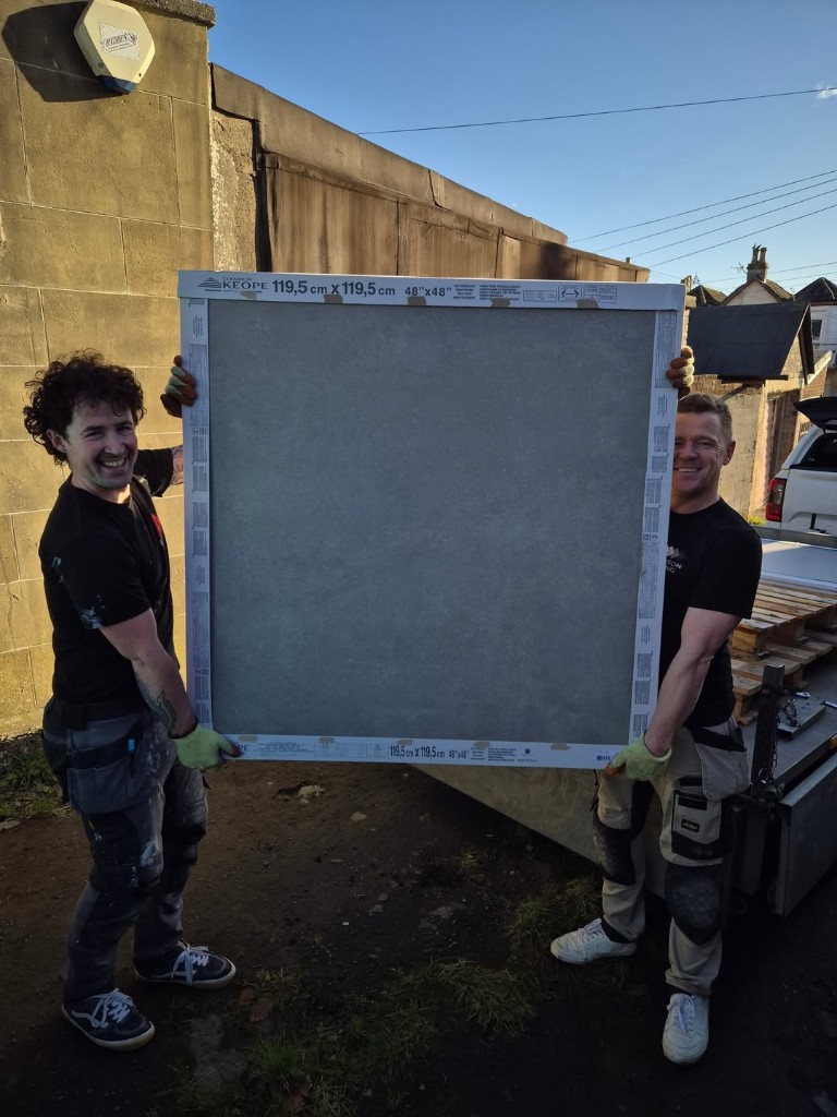 Marc on site holding a large-format porcelain tile